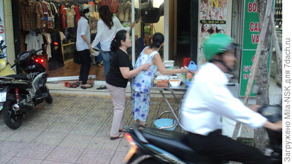 Во здесь видно столики с едой на одной из улиц Нячанга