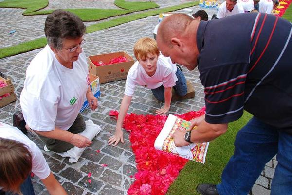 Работа волонтёров над созданием ковра из цветов. Фото с сайта flowercarpet.be