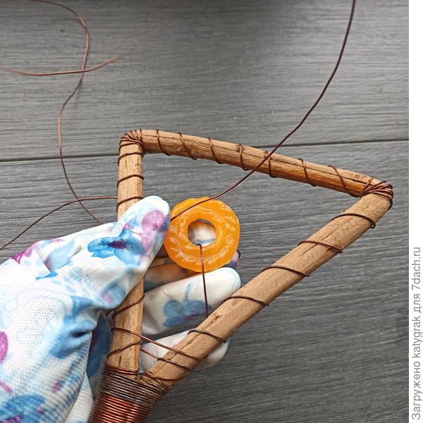 Держа кольцо в середине треугольника приматывала их друг к другу проволокой